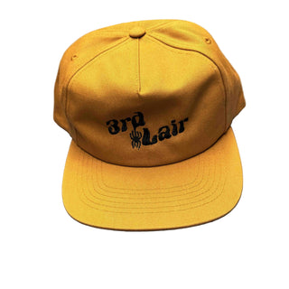 copper colored cap with text and logo on a gray surface