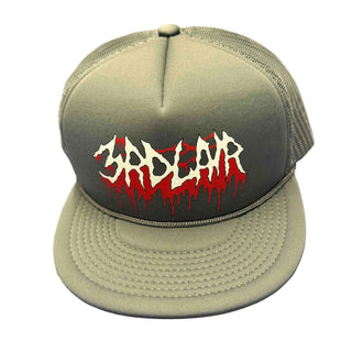 Grey cap with red and white text on a gray surface