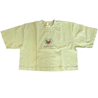 Light green t-shirt with a logo on a dark textured surface