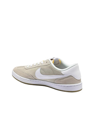 Beige sneaker with white swoosh logo on a light gray background