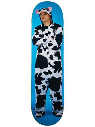 Person wearing a cow onesie standing on a blue skateboard deck