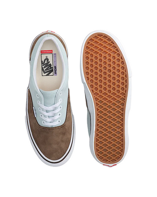 Brown and white sneaker with a focus on sole texture on a light beige background