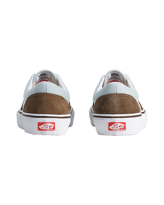 Pair of Vans sneakers with brown and white soles on a light background