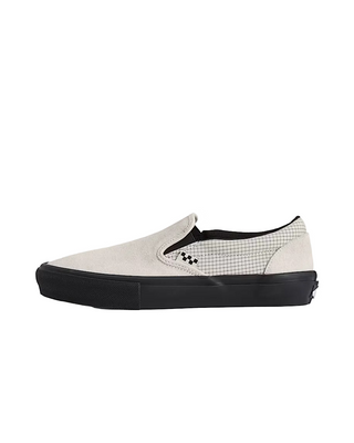 A slip-on platform sneaker in light gray canvas with a black and white checkered side detail, a thick black platform sole, and a black interior lining, shown against a solid off-white background.