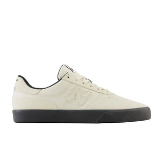 White sneaker with black sole on a white background