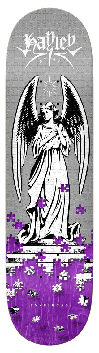Skateboard deck with angel design and 'Hayley' branding on a gray and purple background.