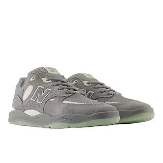 Gray sneakers with green accents on a white background