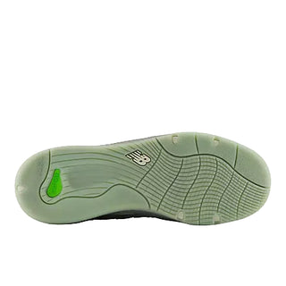 Green sneaker with a visible brand logo on a white background